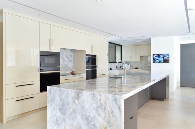 Cristallo quartzite featured in modern kitchen with beige cabinets